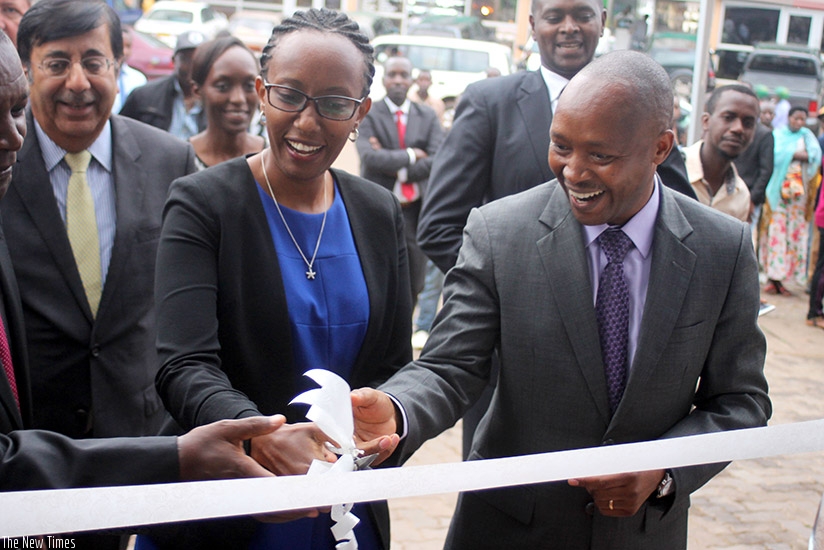 Peace Uwase, the director in charge of financial stability at BNR (centre) with BPR new boss Toroitich officially unveil the new branch at Kisementi as Sanjeev, the new group CEO, ....