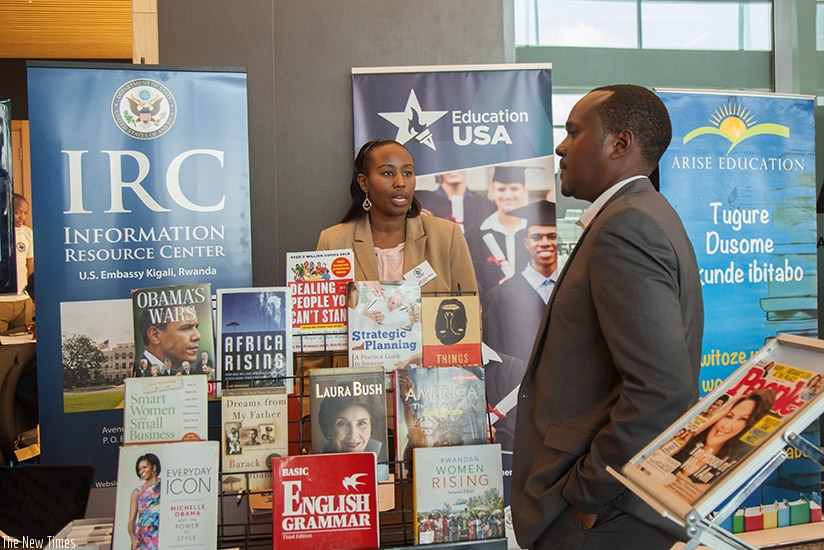 Thais Ruboneka, the information resource centre director at the US Embassy in Kigali talks to a visitor during the book exhibition as part of International Literacy Day yesterday. ....