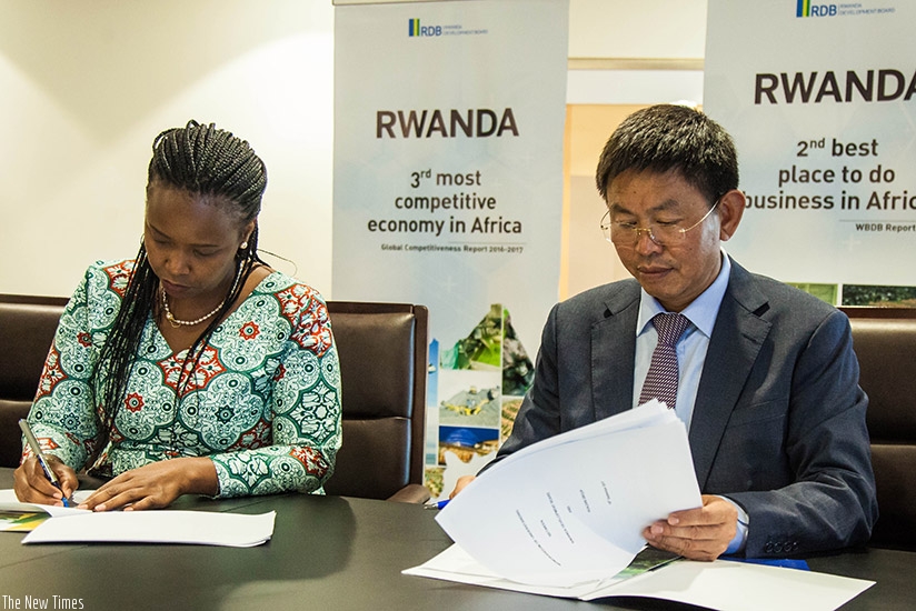 Akamanzi (L) and Zhang sign the MoU to setup a manufacturing plant. Nadege Imbabazi. 