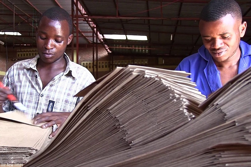 Youth engaged in making paper bags in Kigali. Other countries in the region have joined the efforts of using bio-degradable paper instead of plastic bags. File