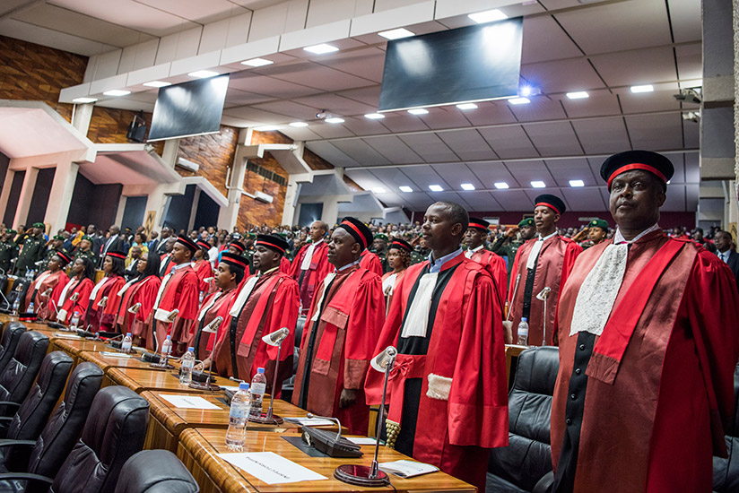A cross section of senior judicial officers observe the National Anthem at the launch of the Judicial Year at parliament on Monday. (Courtesy)