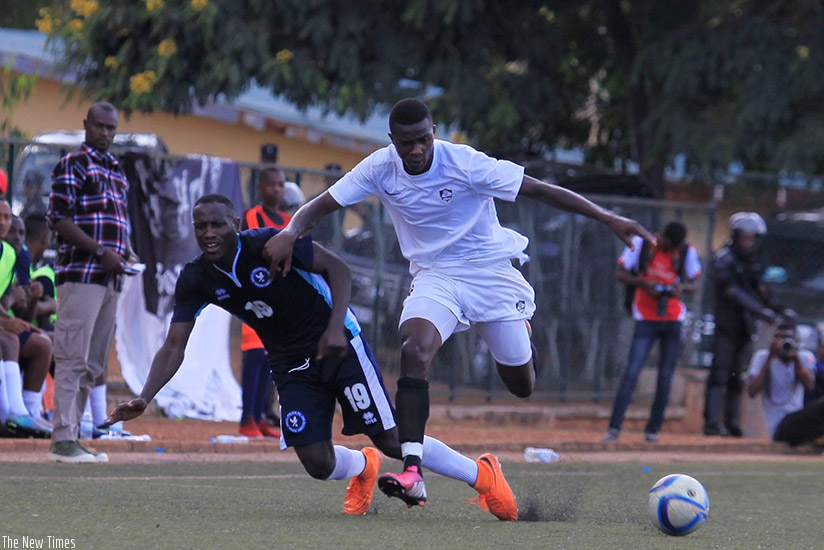 APR FC winger Emmanuel Imanishimwe dribbles past a Police FC defender last season. The Army side team will face the Law enforcers on Wednesday. (S. Ngendahimana)