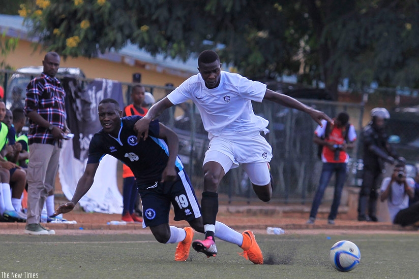 APR FC winger Emmanuel Imanishimwe dribbles past a Police FC defender last season. The Army side team will face the Law enforcers on Wednesday. (S. Ngendahimana)