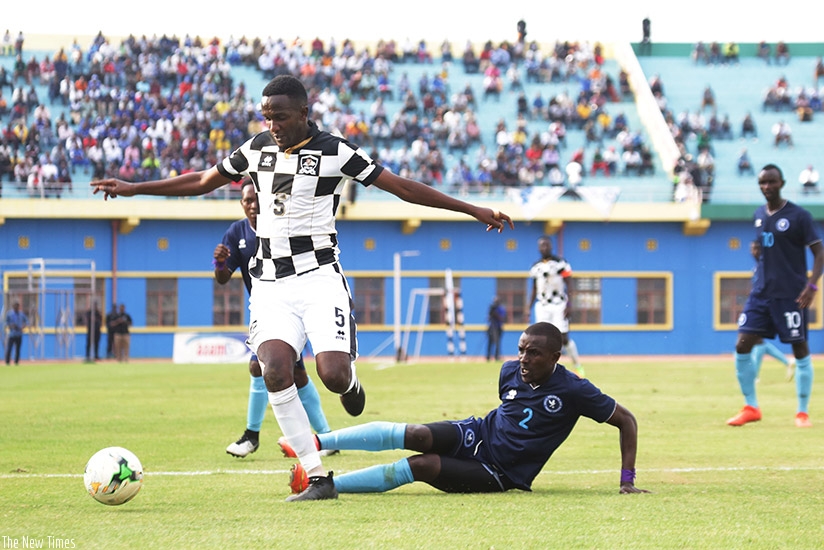 APR FC midfielder Imran Nshimiyimana beats Police FC defender Fiston Munezero  to the  ball during the Agaciro Development Fund fixture at Amahoro National Stadium yesterday.  (S. ....