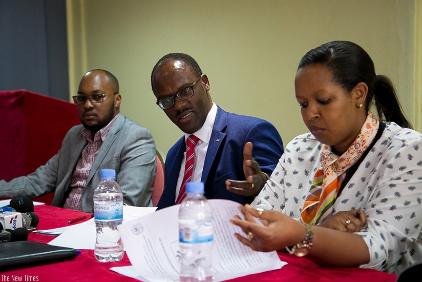 Ndayisaba (C) addresses the media on Thursday as Never Again 's Dr Joseph Nkurunziza (L) and Laetitia Umutirabura, from the Ministry of Gender and Family Promotion, look on. Fausti....