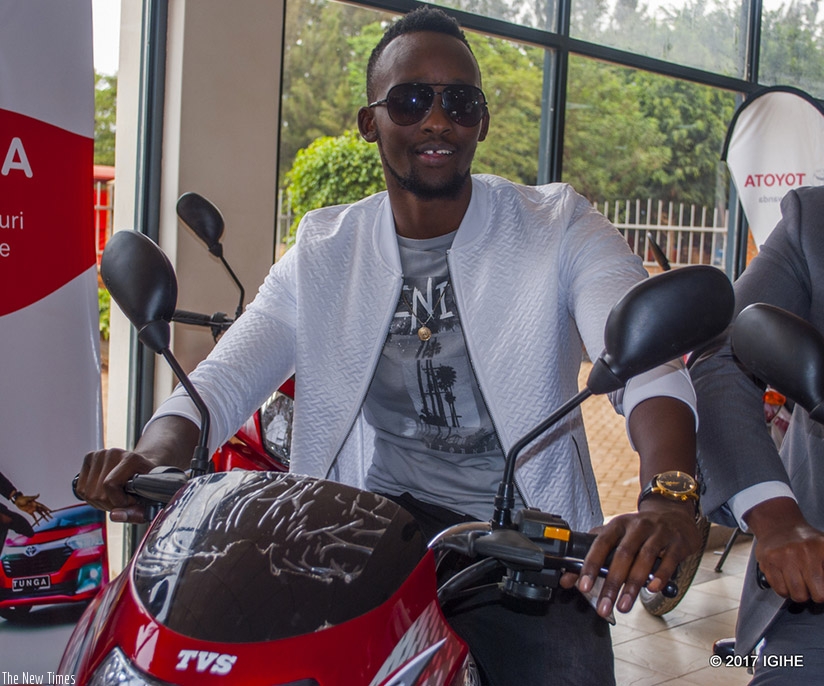 Meddie unveils some of the motorbikes to be won in the Tunga promotion. Net photos 