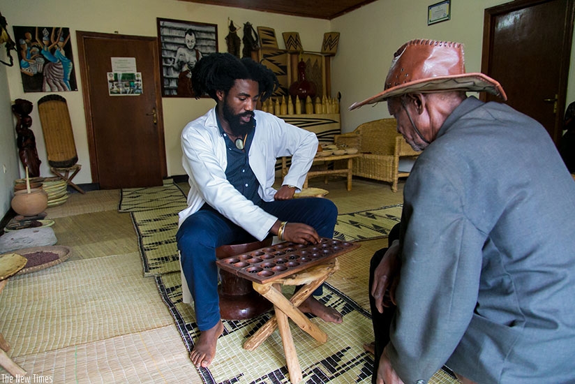 Traditional Rwandan board game is one of the tools used by Rutangarwamaboko to heal his patients. / Faustin Niyigena