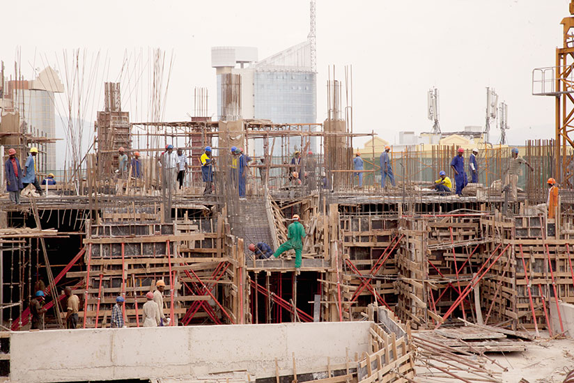 Workers on a construction site in Kigali City. / File photo