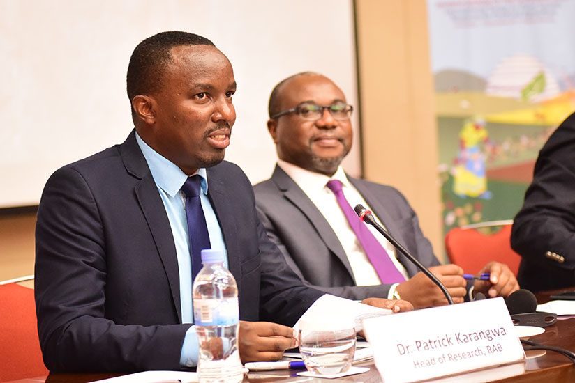 Dr Patrick Karangwa, the director of research at Rwanda Agriculture Board (L), speaks during the African Union Regional Workshop on the Implementation of the International Treaty o....