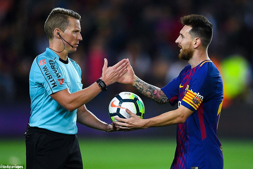 Messi collects the match ball from referee Alejandro Jose Hernandez following Barcelona's 6-1 victory over Eibar. Net photo