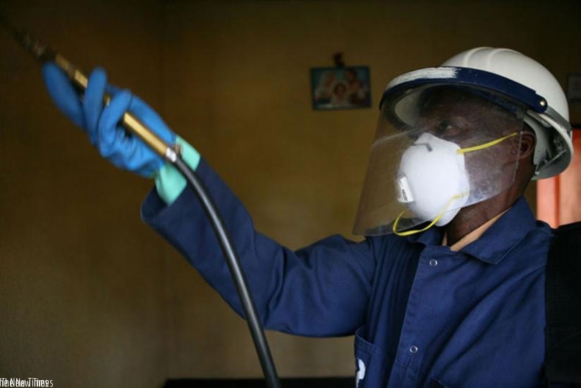 A technician carries out  indoor residual spraying in a house in Bugeseera District. File.