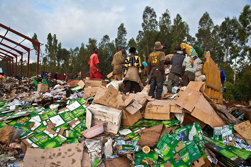Workers  at Nduba dump site in Gasabo District sort out gabbage. Timothy Kisambira.