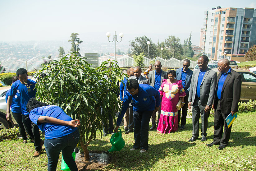 Speaker of the Chamber of Deputies Donatille Mukabalisa (C) waters a tree together with some youth representatives as other officials look on during the International Day of Peace ....