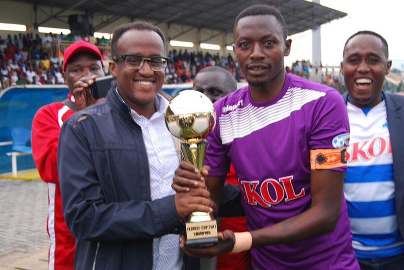 Rayon Sports president Denis Gacinya, left, and skipper Jean Luc Ndayishimiye celebrating with the trophy after winning the first edition of FEZA Cup on Wednesday. / Courtesy