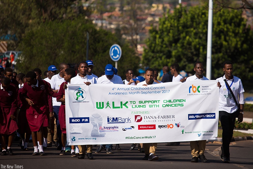 Students of Camp Kigali secondary school and officials of Rwanda Children's Cancer Relief (RCCR) during the annual childhood cancer walk on Friday. / Timothy Kisambira