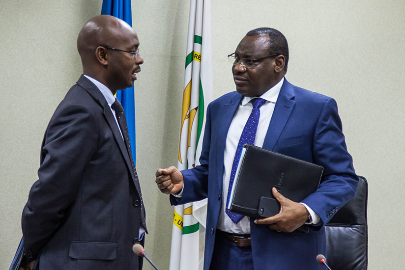 Finance and Economic Planning Minister Claver Gatete (R) chats to Yusuf Murangwa, the DG of the National Institute of Statistics of Rwanda during the presentation of the report on ....