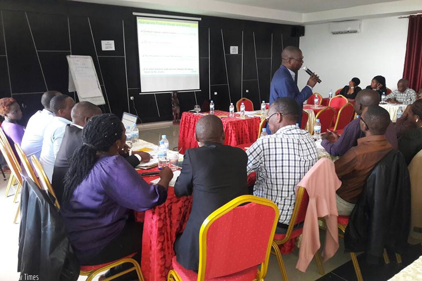 Participants listen to one of the trainers. / Joan Mbabazi
