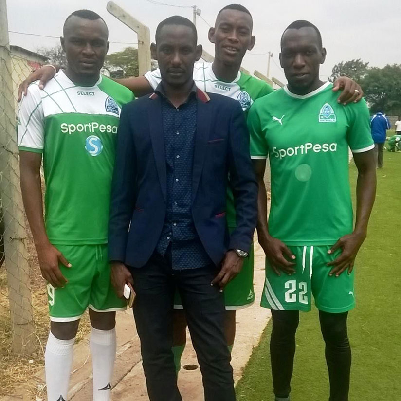 Gakumba pose for a photo with Rwandan players Kagere (left), Tuyisenge (right) and Mugiraneza. He was involved in their moves to Gor Mahia. / Courtesy