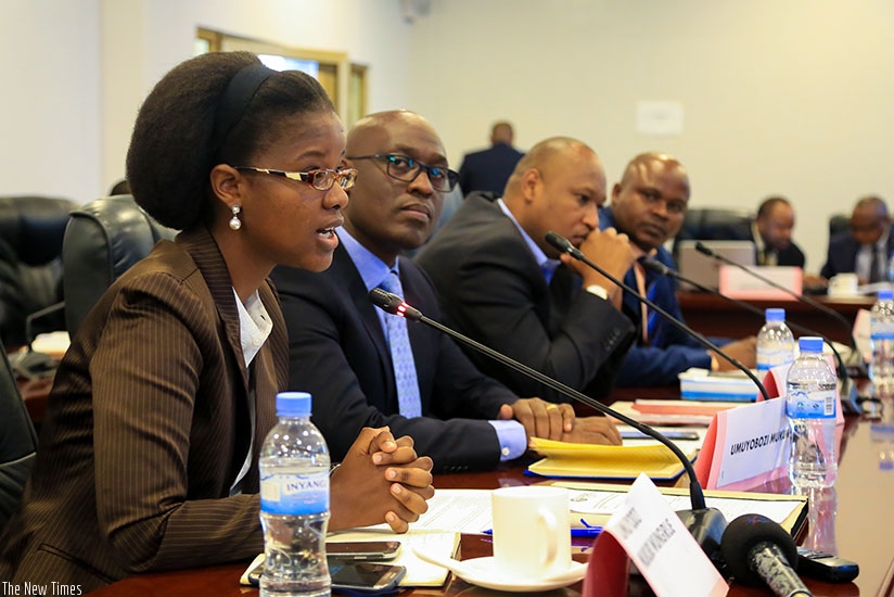 Gisele Umuhumuza, the deputy chief executive of WASAC, speaks during the PAC hearing yesterday. Looking on is Muzola. / Faustin Niyigena