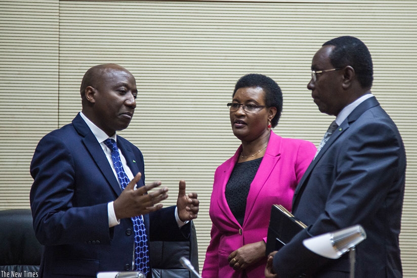 Prime Minister Edouard Ngirente (L) chats with Speaker of the Chamber of Deputies Donatille Mukabalisa (C) and Senate president Bernard Makuza after presentation of the Government'....