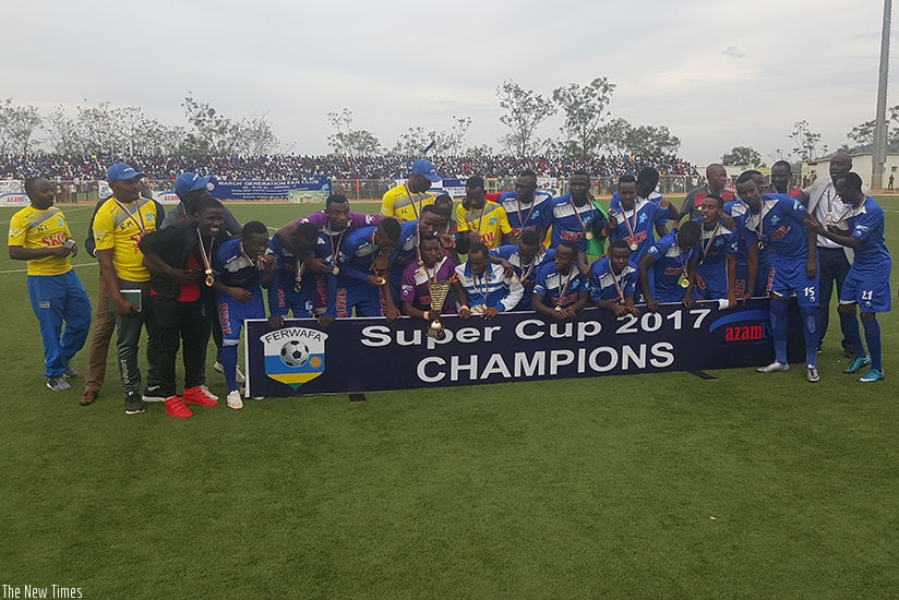 Rayon Sports players and officials celebrate after winning this year's delayed Super Cup on Wednesday at Kigali Stadium. / Peter Kamasa
