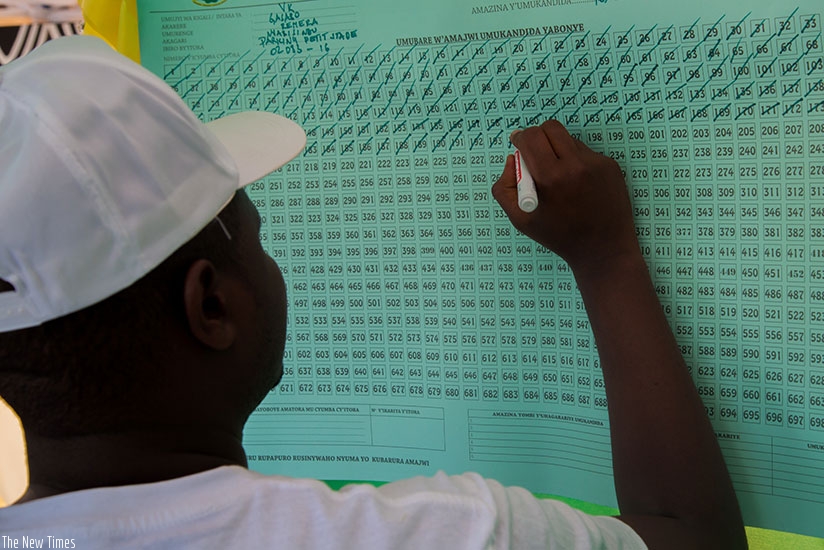 A polling agent tallies votes during the recent presidential elections in Remera, Gasabo District. Timothy Kisambira.