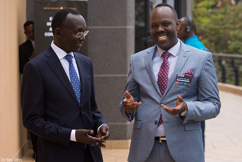 Prof. Rugege (L) chats with Masengo after the meeting in Kigali yesterday. T. Kisambira.