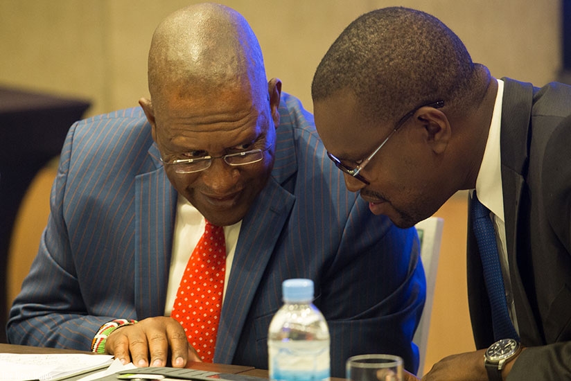 Keriako Tobiko, the director of Public Prosecutions of Kenya (L), chats with his Rwandan counterpart Jean Bosco Mutangana during the 6th annual general meeting of East African Asso....