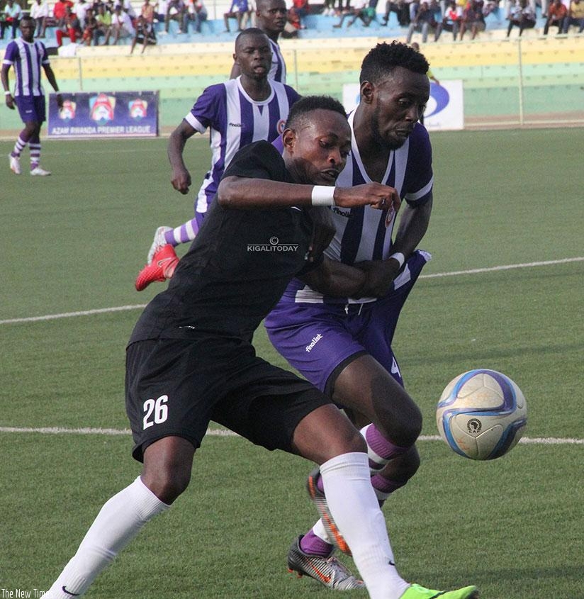 APR FC forward Issa Bigirimana is challenged by a Sunrise defender during Saturday's league opener at Kigali Stadium. Courtesy