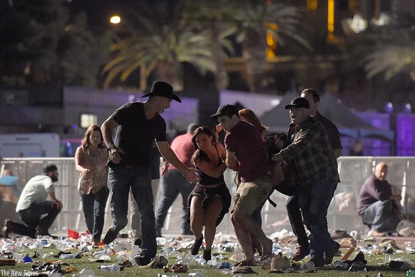 People flee at the Route 91 Harvest country music festival as a gunman opens fire from the Mandelay Bay Resort across the road. (Net photos)