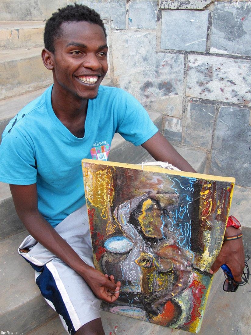 Rukundo shows off one of his paintings.  (Courtesy)