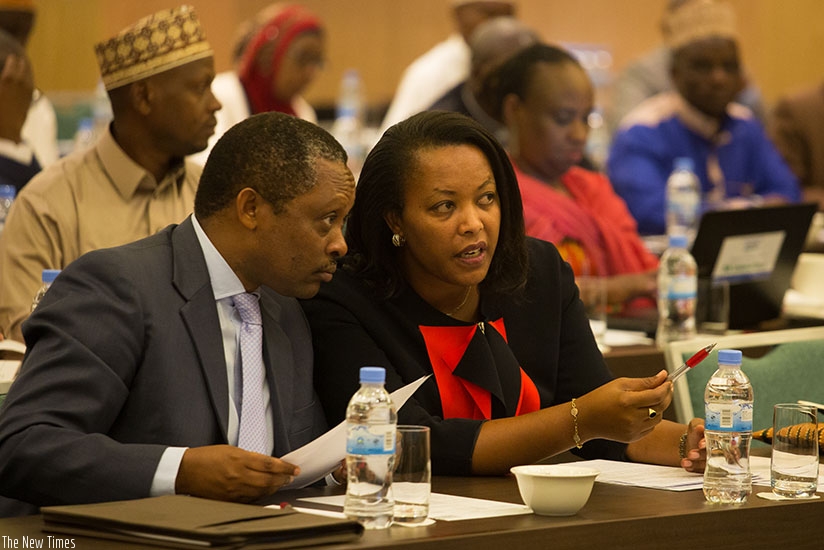 Prof. Anastase Shyaka, the chief executive of Rwanda Governance Board (L), chats with Gender and Family Promotion minister Esperance Nyirasafari during yesterday's  meeting. (All p....