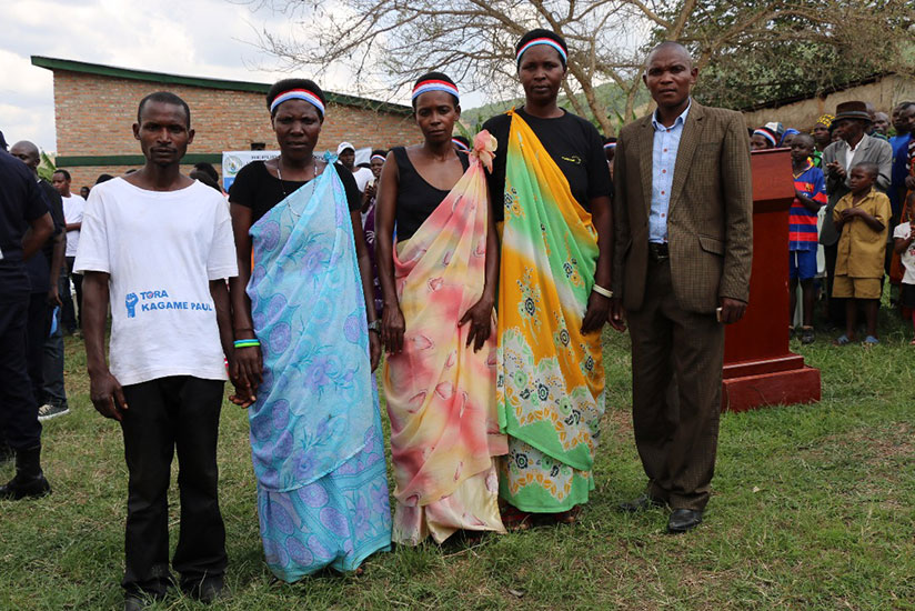 Patrick Bimenyimana extreme with his miracle village committee. / Courtesy