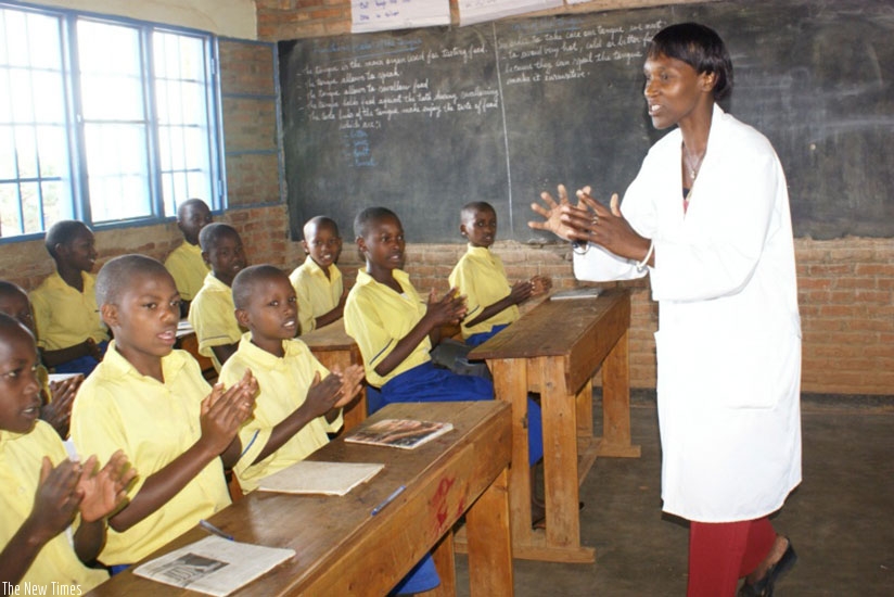 A primary school teacher leads her learners in a song. File.