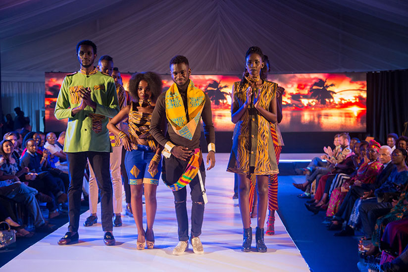 Fashion designer David Gulu (centre) from Dr Congo with his models at the Kigali Fashion Week 2017.