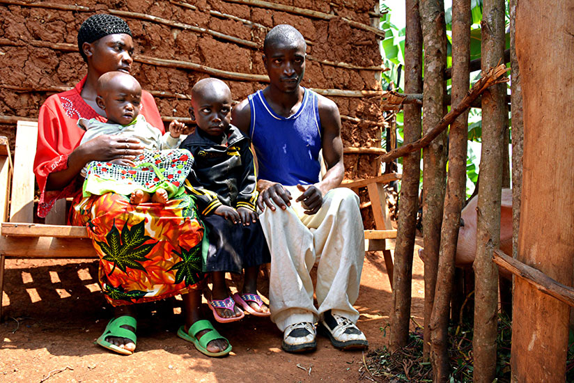 Jacqueline with her husband and children outside their home.