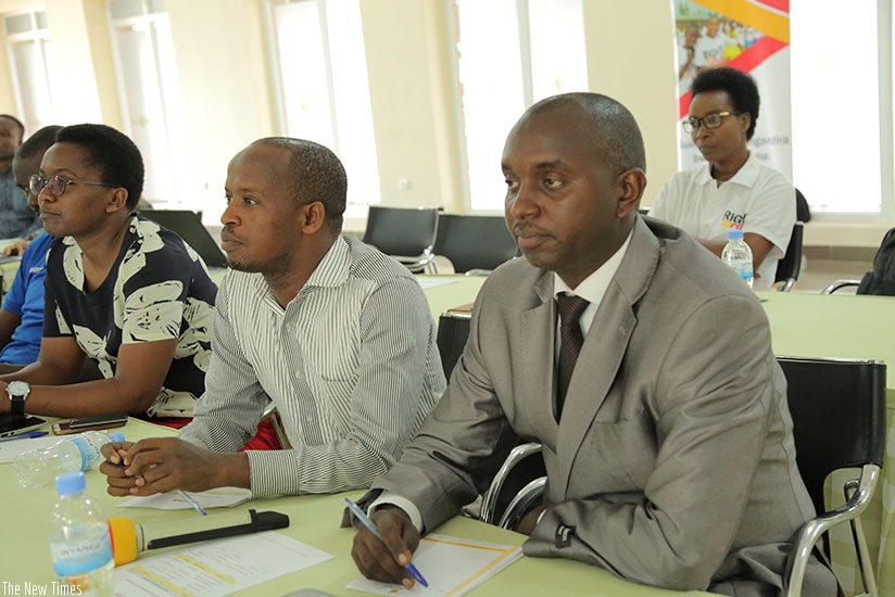 Participants follow proceedings at the conference.  (Francis Byaruhanga)