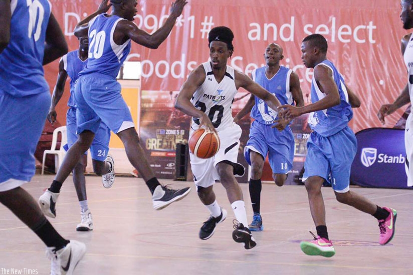 Point-guard Hamza Ruhezamihigo dribbles the ball past ABC players during the just concluded Zone V Club Championships in Kampala. (File)