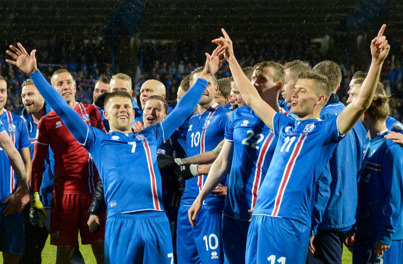 Iceland's players including Iceland's forward Johann Berg Gudmundsson (L) and Iceland's forward Alfred Finnbogason celebrate after the FIFA World Cup 2018 qualification football ma....
