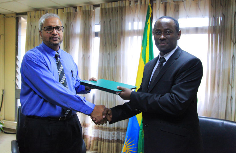 Prof Sid Nair exchanges documents with Dr Emmanuel Muvunyi after signing the MoU in Kigali yesterday. / Sam Ngendahimana