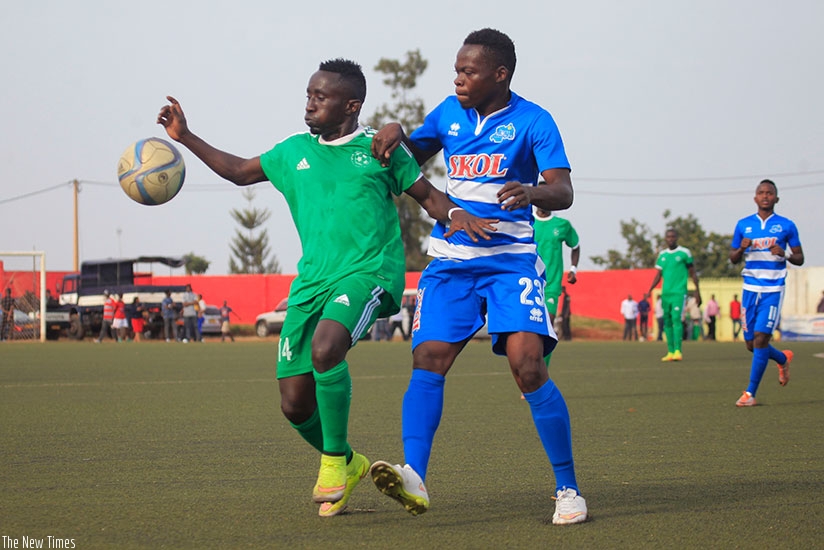 Kiyovu midfielder Jean Paul Havugimana, left, protects the ball against Pierrot Kwizera of Rayon Sports during the final game of last season, which the later won 2-1. rnSam Ngendahimana