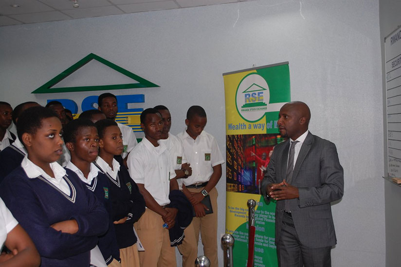 Rwabukumba talks to students during this year's Money Week in March. The local bourse still needs more products to attract new investors, like students, to the market. / File