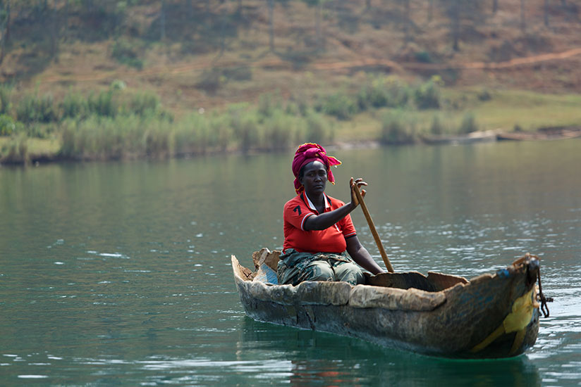 Mukayiranga on Lake Kivu to check on her nets. The fisher wakes up about 5am daily to inspect the nets cast out overnight. / Timothy Kisambira