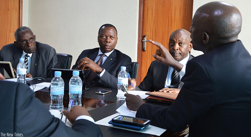 Members of the senatorial Standing Committee on Economic Development and Finance  listen to Local Government Minister Francis Kaboneka (R) during the meeting at the Ministry headqu....