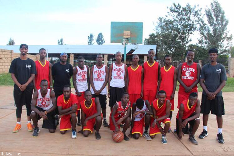 Hamza Ruhezamihigo (standing extreme right) and Lionel Hakizimana (standing extreme left) with young basketball players at New Life Christian Academy in Kayonza after a training se....