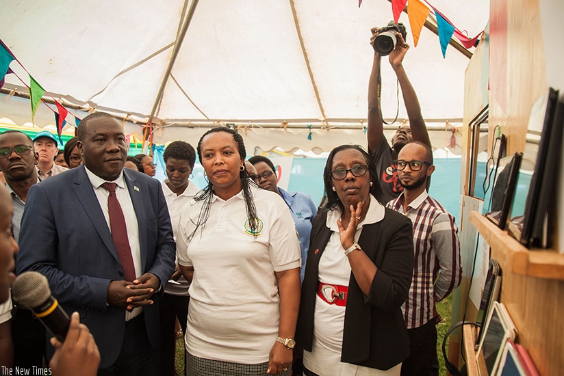 (R-L) Gatabazi, Nyirasafari and Rwabuhihi visit Ninyampinga exhibition stand during the launch of a three-day exhibition in the framework of 'Gender Accountability Day' in Rulindo ....