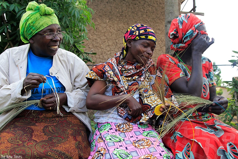 Women under a cooperative weave baskets in Musanze District. Sam Ngendahimana. 