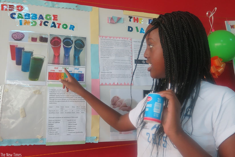 A student explains her project to an audience. Creativity promotes good ideas and smart learning. (Dennis Agaba)