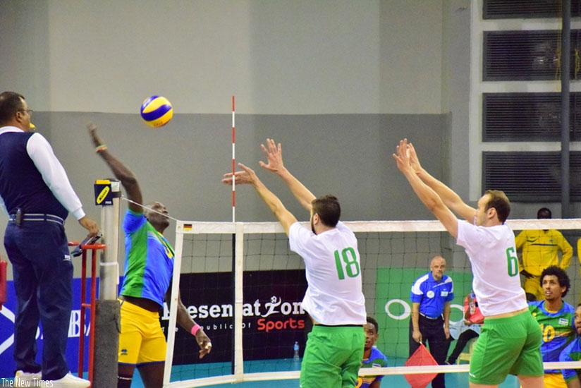 Algeria double block against Rwanda star Lawrence Yakan Guma. (Courtesy photos)