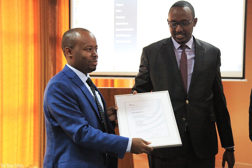 Murenzi (L) and Sebera show off the certificate to participants at an event in Kigali, yesterday.  (Photos by Sam Ngendahimana)